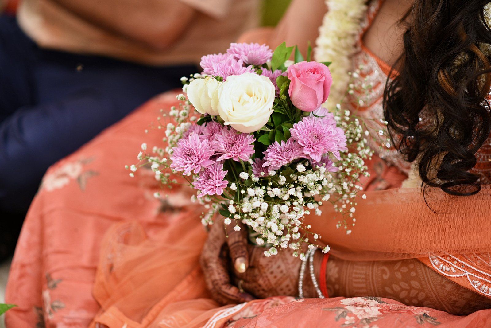 A sample straight out of the pipeline, in ceremony order: arrival at the resort, a bouquet held in mehndi-decorated hands from Seemant Poojan, a Haldi portrait of the groom in a yellow kurta beside a flowering hedge, Lagna Vidhi, the bride's entry at Mangalashtak, the Varat shot from the drone, reception portraits (photographer-graded passthrough), and a Sangeet stage performance under the adaptive-gamma night grade.