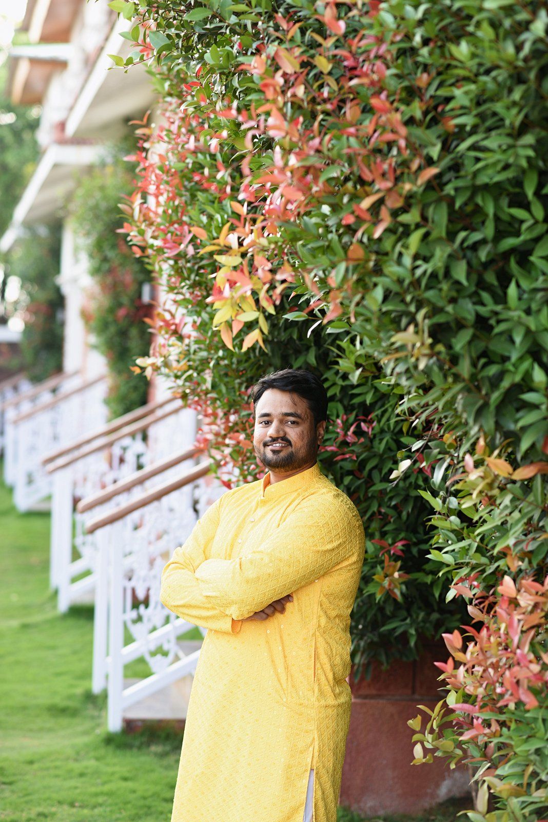 A sample straight out of the pipeline, in ceremony order: arrival at the resort, a bouquet held in mehndi-decorated hands from Seemant Poojan, a Haldi portrait of the groom in a yellow kurta beside a flowering hedge, Lagna Vidhi, the bride's entry at Mangalashtak, the Varat shot from the drone, reception portraits (photographer-graded passthrough), and a Sangeet stage performance under the adaptive-gamma night grade.