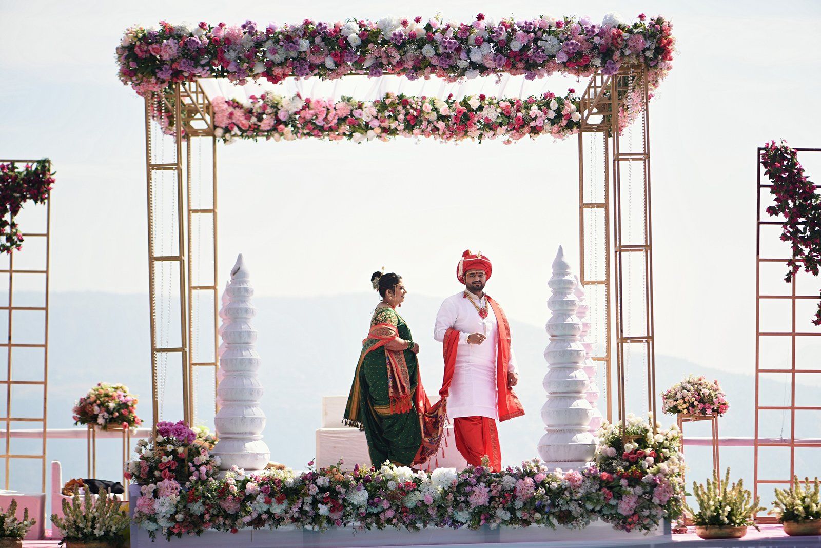 Lagna Vidhi, Rockford Resort, Mahabaleshwar, 21 December 2023: under the flower-hung mandap, the Sahyadri ridgeline falls away behind us into haze — the reason we picked a hilltop venue in the first place.